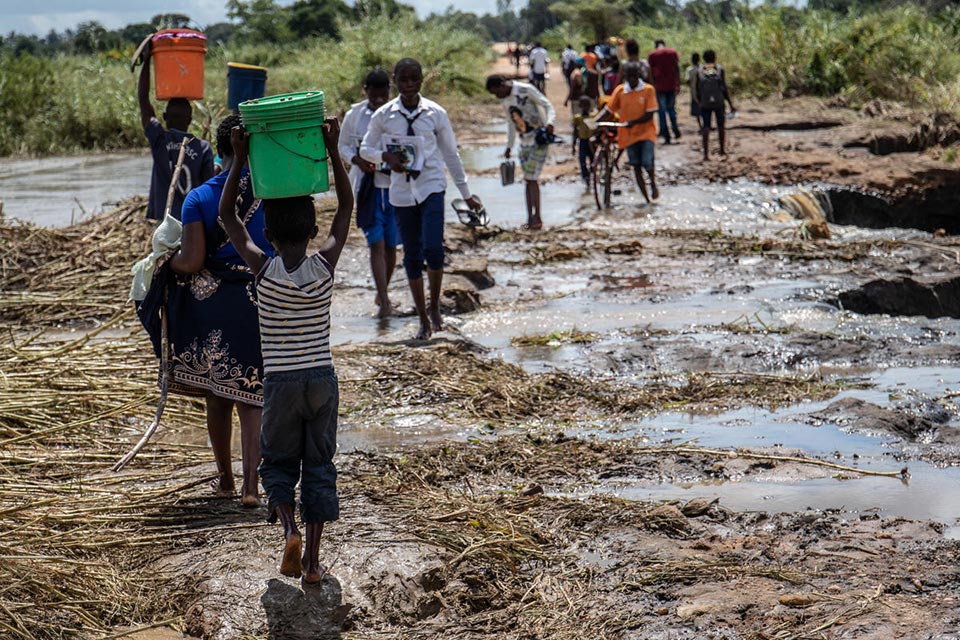 Child carrying water after Cyclone Kenneth hit Mozambique