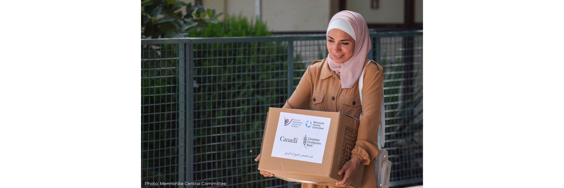 Basima carrying a package