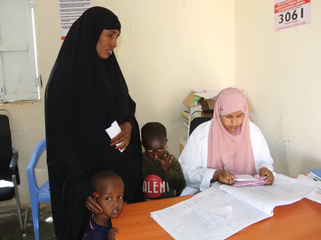 Amina receiving assistance from nurse Jamila at the health center